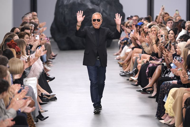 Designer Michael Kors waves to the crowd at the end of the Michael Kors Collection spring/summer 2025 fashion show as part of New York Fashion Week, Tuesday, Sept. 10, 2024, in New York. (AP Photo/Pamela Smith)