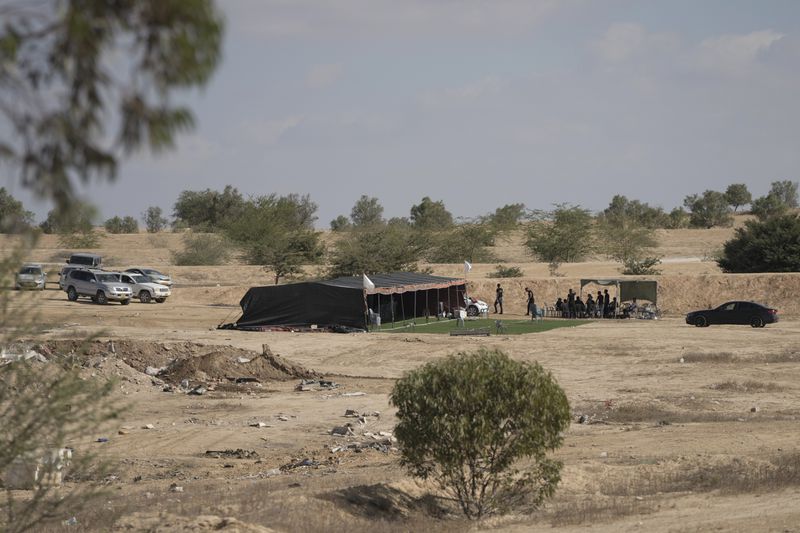 Relatives and friends of Qaid Farhan Alkadi, 52, who was held hostage by Hamas militants in Gaza Strip, wait for his arrival on an area in the Khirbet Karkur village, near Rahat, southern Israel, Wednesday, Aug. 28, 2024. (AP Photo/Mahmoud Illean)