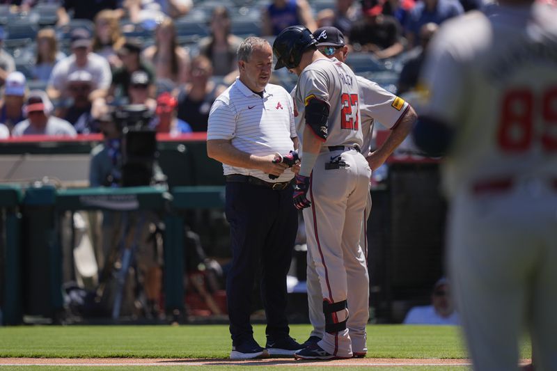 FILE - Atlanta Braves third baseman Austin Riley (27) is checked out after taking a pitch to the hand during the first inning of a baseball game against the Los Angeles Angels, Sunday, Aug. 18, 2024, in Anaheim, Calif. (AP Photo/Ryan Sun, File)