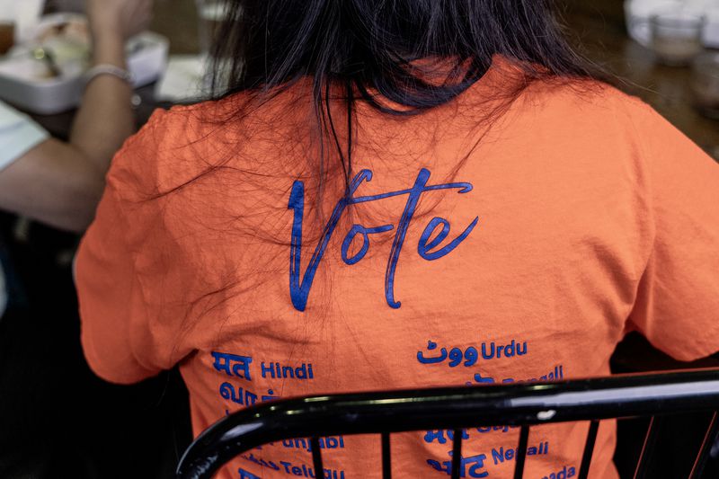 Sujatha Srikanth, a board member with South Asian Americans for Voter Empowerment of Texas, wears a shirt with the word “Vote” in different South Asian languages during an event in Houston on June 19, 2024. Her group is one of many fighting disinformation targeting communities of color. (Eliana Alzate/News21)