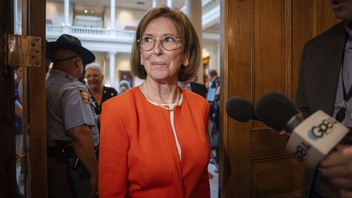 Dr. Janice Johnston, a member of the State Election Board, enters after a brief recess during a meeting at the Capitol in Atlanta, Tuesday, Aug. 6, 2024. (Matthew Pearson/WABE via AP)