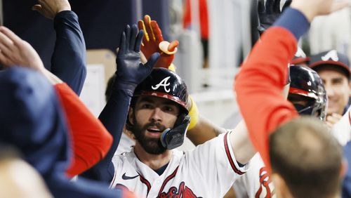 Braves shortstop Dansby Swanson (7) gets high fives in the dugout after hitting a two-run home run during the fifth inning of a baseball game against the New York Mets at Truist Park on Saturday, Oct. 1, 2022. Miguel Martinez / miguel.martinezjimenez@ajc.com