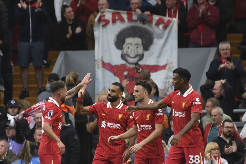 FILE - Liverpool's Mohamed Salah, centre, celebrates with teammates after scoring his side's second goal during the English Premier League soccer match between Liverpool and Brentford at Anfield Stadium, Liverpool, England, Sunday, Aug. 25, 2024. (AP Photo/Rui Vieira, File)