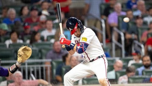 Atlanta Braves' Whit Merrifield (15) is hit by a pitch from the Rockies in the seventh inning at Truist Park in Atlanta on Tuesday, September 3, 2024. (Arvin Temkar / AJC)