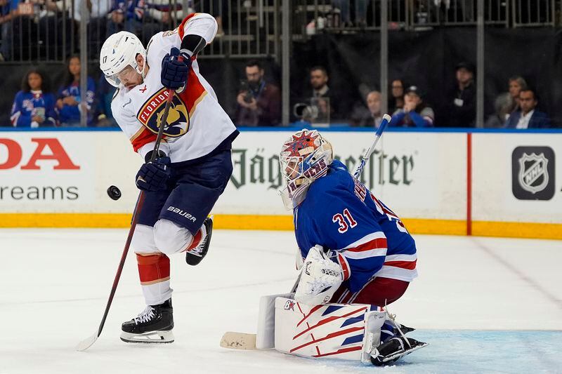 Florida Panthers center Evan Rodrigues (17) controls a rebound as New York Rangers goaltender Igor Shesterkin (31) defends during the third period of Game 1 of the NHL hockey Eastern Conference Stanley Cup playoff finals, Wednesday, May 22, 2024, in New York. (AP Photo/Julia Nikhinson)