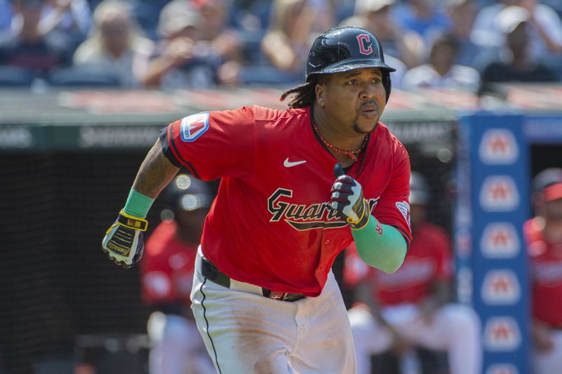 Cleveland Guardians' Jose Ramirez runs to first base after hitting a double off Kansas City Royals relief pitcher Kris Bubic during the seventh inning of the first game of a baseball doubleheader in Cleveland, Monday, Aug. 26, 2024. (AP Photo/Phil Long)