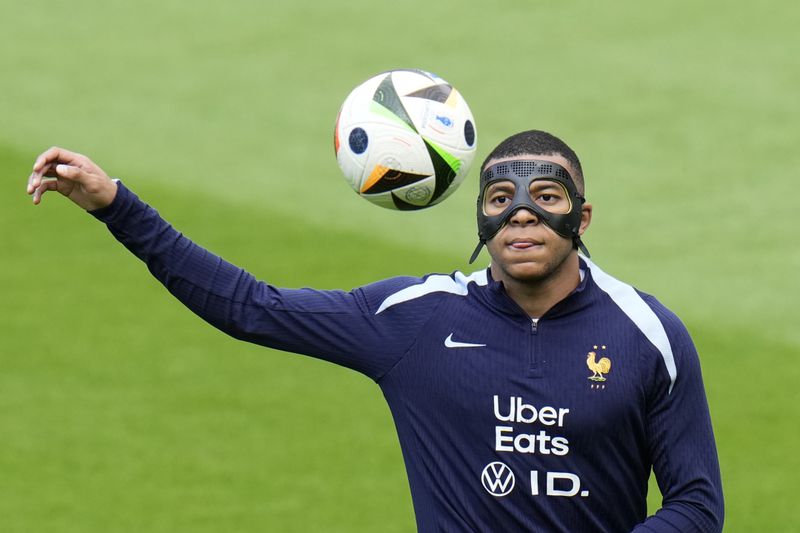 France's Kylian Mbappe controls the ball during a training session in Paderborn, Germany, Sunday, June 23, 2024. France will play against Poland during their Group D soccer match at the Euro 2024 soccer tournament on June 25. (AP Photo/Hassan Ammar)