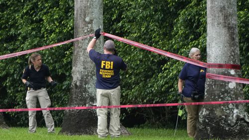 Law enforcement officials work at the scene of the Trump International Golf Club in the aftermath of the apparent assassination attempt of Republican presidential nominee and former President Donald Trump Tuesday, Sept. 17, 2024, in West Palm Beach, Fla. (AP Photo/Lynne Sladky)