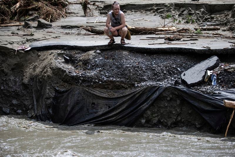 A resident of Plainfield watches the aftermath of the flash flood site which has hit Central Vermont last night, Thursday, July 11, 2024. (AP Photo/Dmitry Belyakov)