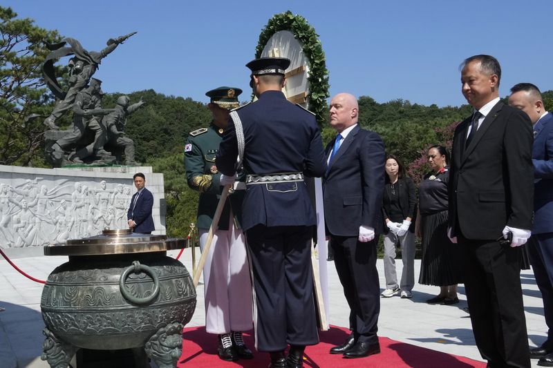 New Zealand's Prime Minister Christopher Luxon, center, lays a wreath during a visit to National Cemetery in Seoul, South Korea, Wednesday, Sept. 4, 2024. (AP Photo/Ahn Young-joon)