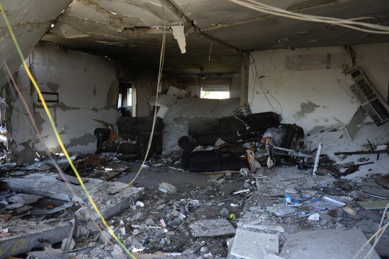 A home destroyed by rockets in Katzrin, in the the Israeli-annexed Golan Heights, Wednesday, Aug. 21, 2024. Lebanon's Hezbollah has launched more than 50 rockets, hitting a number of private homes in the area.(AP Photo/Ariel Schalit)