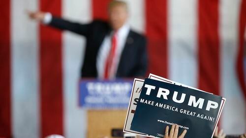 A supporter holds a sign as Republican presidential candidate Donald Trump speaks at a rally, Friday, May 6, 2016, in Omaha, Neb. (AP Photo/Charlie Neibergall)