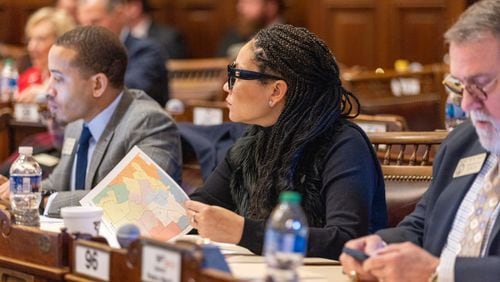 State House Rep. Inga Willis, D-Atlanta, reviews a map during discussion of redistricting bill SB 3EX during the special legislative session Thursday at the Georgia Capitol in Atlanta. (Arvin Temkar / arvin.temkar@ajc.com)