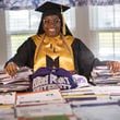 Liberty County High School graduate Madison Crowell, who has received college scholarship offers totaling more than $14 million, poses with some of the offers laid out on her family's dining room table on Wednesday, May 29, 2024 in Hinesville, Georgia. (AJC Photo/Stephen B. Morton)