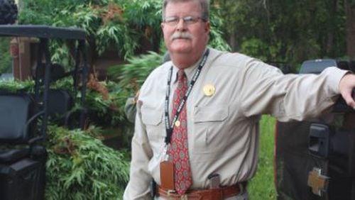 Monroe County Sheriff John Cary Bittick poses in front of a few of the 23,000 marijuana plants seized last week. (Credit: Monroe County Sheriff’s Office)