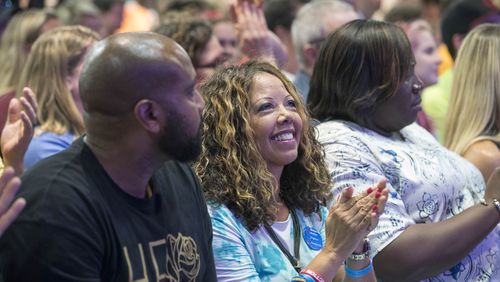 Lucy McBath (center), the Democratic candidate for the 6th Congressional District, claps for members of a panel during a March For Our Lives rally at Eagles Nest Church in Roswell on July 30, 2018.  (ALYSSA POINTER/ALYSSA.POINTER@AJC.COM)