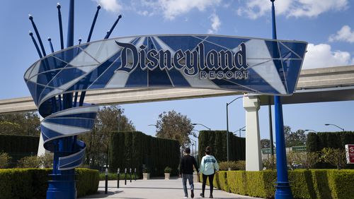 FILE - The Disneyland Resort entrance is seen, March 9, 2021, in Anaheim, Calif. Disney has reached a tentative agreement with four unions representing thousands of workers at its California theme parks, including ride operators, candy makers and parking attendants. (AP Photo/Jae C. Hong, File)
