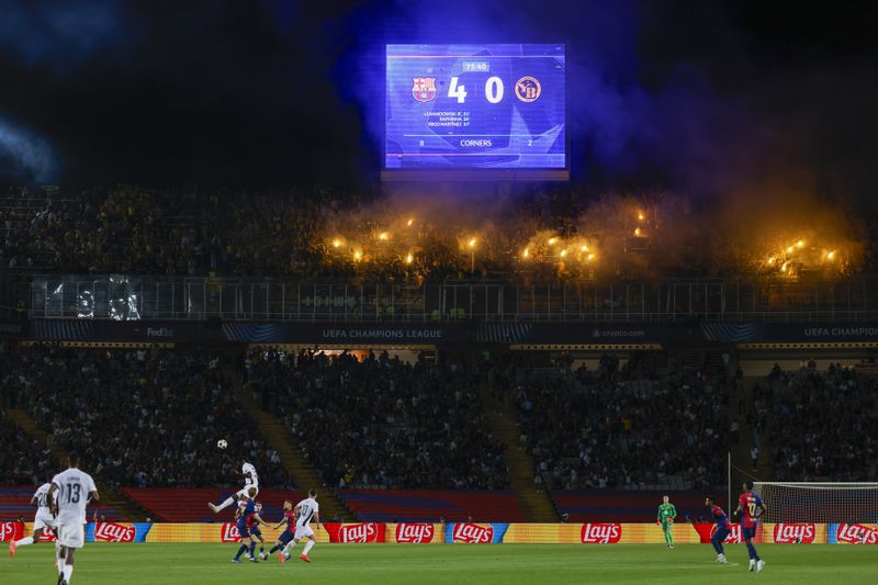 Supporters fire flares during the Champions League soccer match between Barcelona and Young Boys at the Lluis Companys Olympic Stadium in Barcelona, Spain, Tuesday, Oct. 1, 2024. (AP Photo/Joan Monfort)