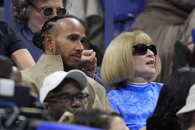 Lewis Hamilton and Anna Wintour watch the women's singles final between Aryna Sabalenka, of Belarus, and Jessica Pegula, of the United States, of the U.S. Open tennis championships, Saturday, Sept. 7, 2024, in New York. (AP Photo/Frank Franklin II)