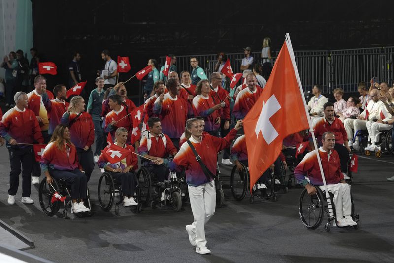 Members of the Swiss delegation parade during the Opening Ceremony for the 2024 Paralympics, Wednesday, Aug. 28, 2024, in Paris, France. (AP Photo/Thibault Camus, Pool)