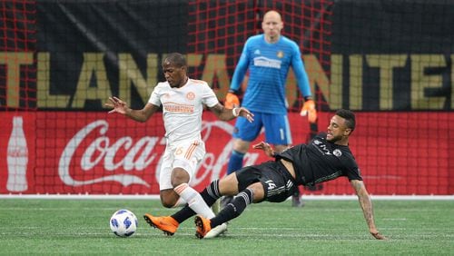 Atlanta United midfielder Darlington Nagbe battles Sporting Kansas City forward Khiry Shelton during the first half Wednesday, May 9, 2018, in Atlanta.