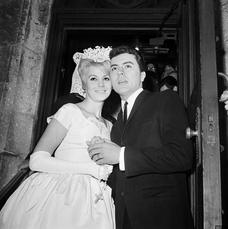 FILE - James Darren and his wife Evy Norlund embrace after their marriage at St. Patrick's Cathedral in New York, Feb. 6, 1960. (AP Photo/Harry Harris, File)