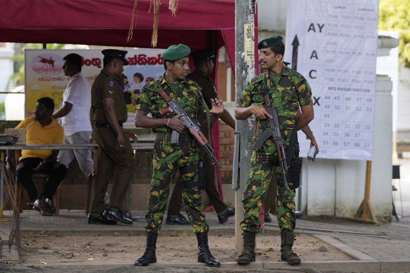 Police commandos stand guard outside a ballot counting center in Colombo, Sri Lanka, Saturday, Sept. 21, 2024. (AP Photo/Eranga Jayawardane)