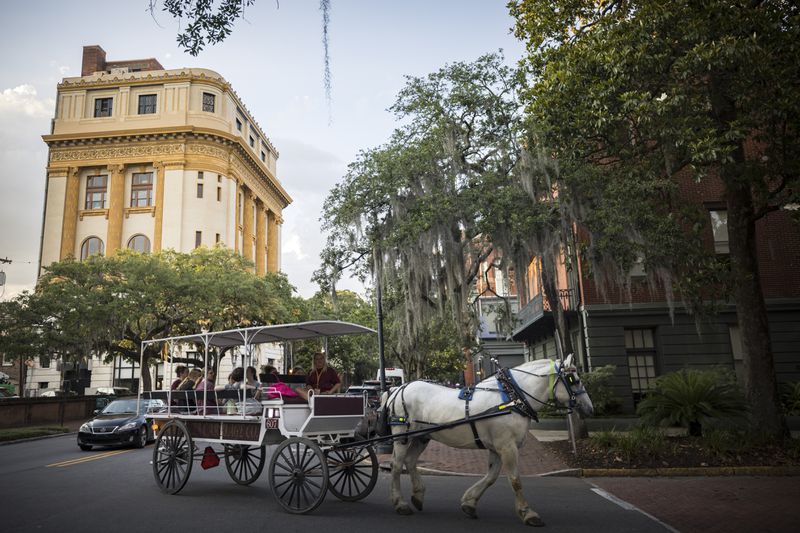 Visitors ride a horse-drawn carriage during a tour of the Landmark Historic District in Savannah.