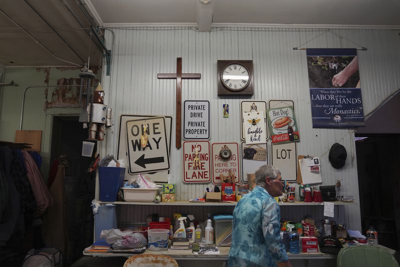 Sister Helen Mueting walks through the community's workshop at the Mount St. Scholastica Benedictine monastery in Atchison, Kan., Tuesday, July 16, 2024. (AP Photo/Jessie Wardarski)