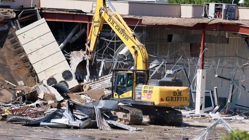 Heavy machinery is seen to demolish part of North Dekalb Mall, signifying the start of development for a new multi-use project on Wednesday, June 26, 2024.
(Miguel Martinez / AJC)