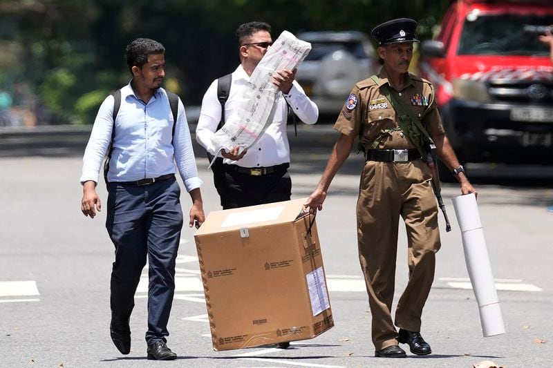 Election officials leave a distribution center after collecting polling material for the upcoming presidential election, in Colombo, Sri Lanka, Friday, Sept. 20, 2024. (AP Photo/Eranga Jayawardena)