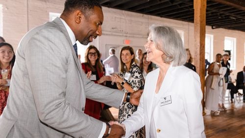 Mayor Andre Dickens (left) with Annette Cone-Skelton, the Museum of Contemporary Art of Georgia's founder and CEO, shake hands during the announcement of the city of Atlanta's contribution to the visual art institution's Grounded building campaign. Courtesy of Dustin Chambers