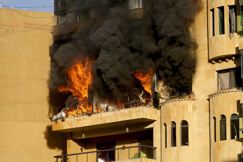 Flames rise from an apartment which caught fire after an Israeli airstrike in Dahieh, Beirut, Lebanon, Wednesday, Oct. 2, 2024. (AP Photo/Hussein Malla)