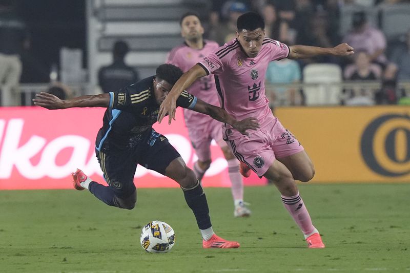 Philadelphia Union defender Nathan Harriel (26) and Inter Miami midfielder Diego GÛmez (20) go after the ball during the first half of an MLS soccer match, Saturday, Sept. 14, 2024, in Fort Lauderdale, Fla. (AP Photo/Marta Lavandier)