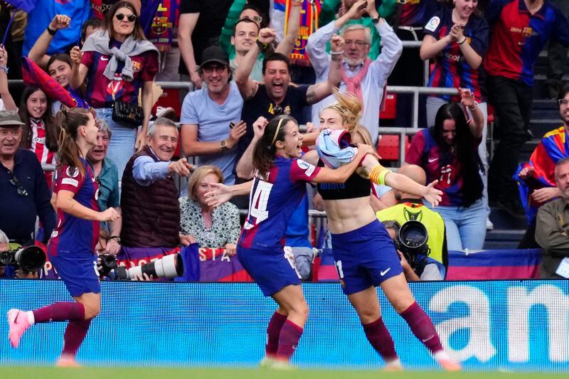Barcelona's Alexia Putellas, right, is congratulated after scoring her side's 2nd goal during the women's Champions League final soccer match between FC Barcelona and Olympique Lyonnais at the San Mames stadium in Bilbao, Spain, Saturday, May 25, 2024. (AP Photo/Jose Breton)