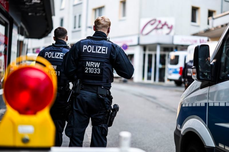 Police officers stand at a cordon in the city center in the early morning in Solingen, Germany, Saturday, Aug. 24, 2024, following Friday's deadly attack at the city's 650th anniversary celebrations. (Christoph Reichwein/dpa via AP)