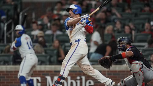 Atlanta Braves outfielder Ramón Laureano (18) hits a solo homer in the eighth inning of a baseball game against the Washington Nationals, Saturday, Aug. 24, 2024, in Atlanta. (AP Photo/Mike Stewart)