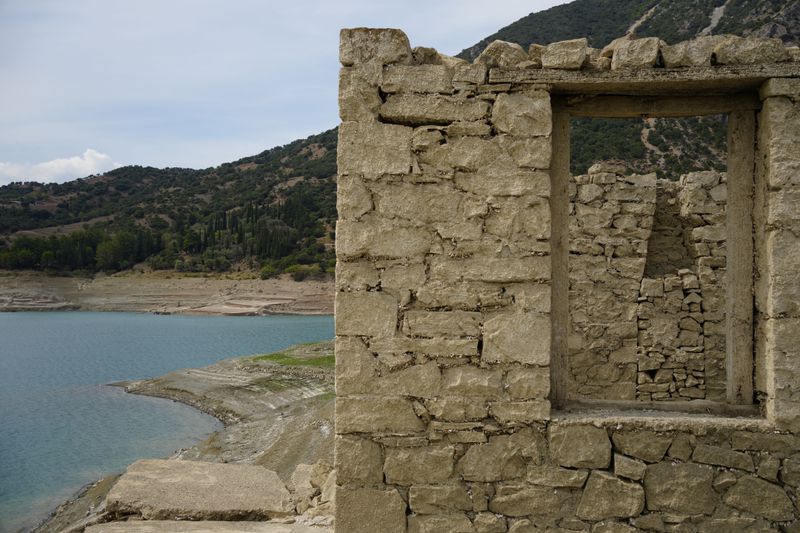 A building is seen in the sunken Kallio village that's resurfaced from the artificial Mornos Lake, the biggest of the four reservoirs supplying drinking water to Greece's capital which is at its lowest level in 16 years, some 200 kilometers (125 miles) northwest from Athens, central Greece, on Thursday, Sept. 5, 2024. (AP Photo/Thanassis Stavrakis)