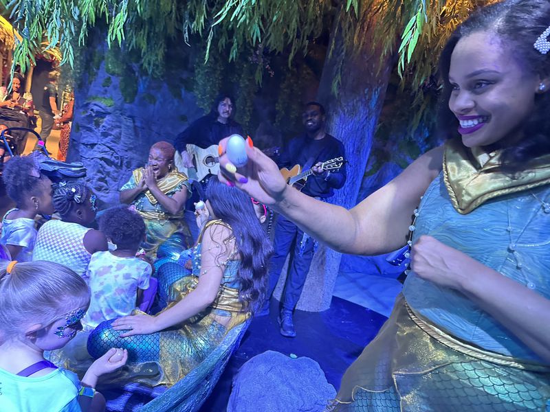 "The Little Mermaid" experience at the CAMP store features songs from the movie sung by actors like Brittani Minnieweather (right). RODNEY HO/rho@ajc.com