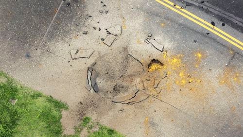 This photo taken from a Kyodo News helicopter shows part of a damaged taxiway at Miyazaki Airport in southwestern Japan, Wednesday, Oct. 2, 2024, after an explosion was reported. (Kyodo News via AP)