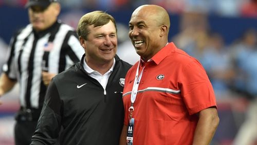 090316 Atlanta: Georgia Bulldogs head coach Kirby Smart  jokess with former Bulldog and NFL star Hines Ward before taking on the North Carolina Tar Heels in the Chick-fil-A Kickoff Game at the Georgia Dome Saturday September 3, 2016. BRANT SANDERLIN/BSANDERLIN@AJC.COM