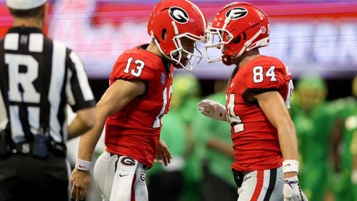 090322 Atlanta.: Georgia Bulldogs quarterback Stetson Bennett (13) celebrates their four-yard touchdown with wide receiver Ladd McConkey (84) during the second quarter against the Oregon Ducks in the Chick-fil-A Kickoff game at Mercedes Benz Stadium, Saturday, September 3, 2022, in Atlanta. (Jason Getz / Jason.Getz@ajc.com)