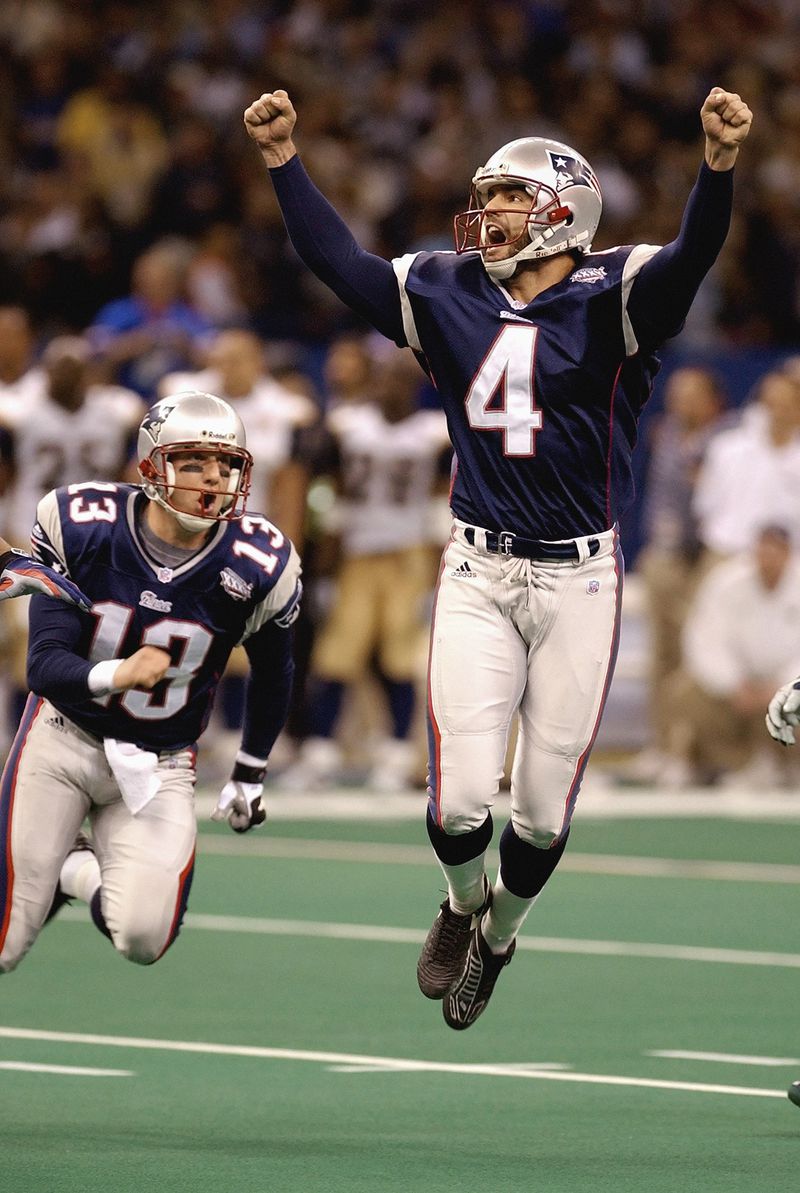 FILE - New England Patriots kicker Adam Vinatieri (4), joined by teammate Ken Walter who held the ball, celebrates his 48-yard game-winning field goal in the final seconds of Super Bowl XXXVI against the St. Louis Rams, Feb. 3, 2002, in New Orleans. (AP Photo/Amy Sancetta, File)