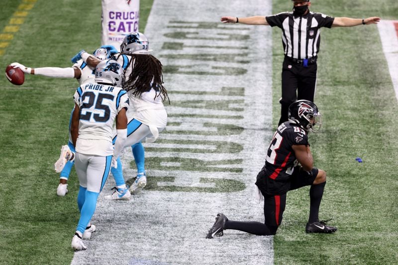 Carolina Panthers safety Juston Burris (left) celebrates with teammates cornerback Troy Pride Jr. (25) and safety Tre Boston intercepting a pass intended for Atlanta Falcons wide receiver Russell Gage (83, right) in the fourth quarter Sunday, Oct. 11, 2020, at Mercedes-Benz Stadium in Atlanta. The Panthers won 23-16. (Jason Getz/For the AJC)