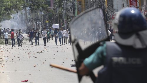 Students clash with riot police during a protest against a quota system for government jobs, in Dhaka, Bangladesh, Thursday, July 18, 2024. (AP Photo/Rajib Dhar)