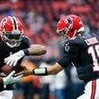 Falcons quarterback Kirk Cousins (18) hands the ball to running back Bijan Robinson (7) during warm-ups before the Falcons face the New Orleans Saints on Sunday, Sept. 29, at Mercedes-Benz Stadium in Atlanta. 
(Miguel Martinez/ AJC)