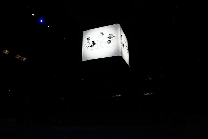 Screens show portraits of Johnny and Matthew Gaudreau during a moment of silence before the NHL hockey game between Buffalo Sabres and New Jersey Devils, in Prague, Czech Republic, Friday, Oct. 4, 2024. (AP Photo/Petr David Josek)