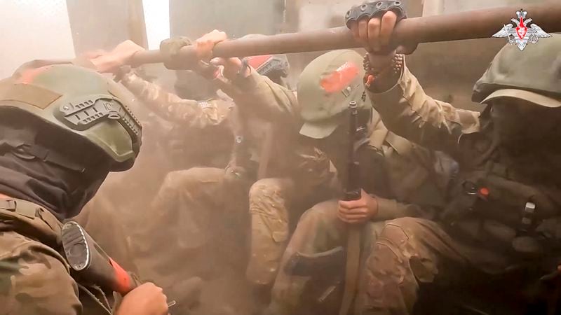 On this photo taken from video released by the Russian Defense Ministry on Monday, Aug. 26, 2024, A Russian assault unit prepare to leave an armoured personal carrier in the direction of Konstantinovka in Ukraine. (Russian Defense Ministry Press Service via AP)