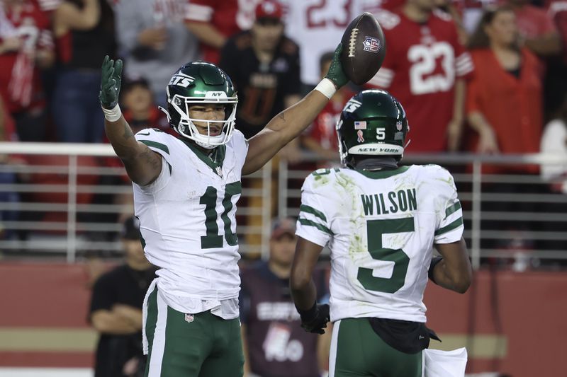 New York Jets wide receiver Allen Lazard (10) celebrates with wide receiver Garrett Wilson (5) after scoring against the San Francisco 49ers during the second half of an NFL football game in Santa Clara, Calif., Monday, Sept. 9, 2024. (AP Photo/Jed Jacobsohn)