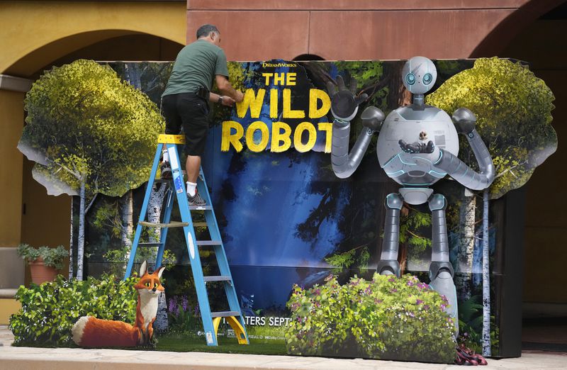 A workman puts the finished touches on a backdrop for the film "The Wild Robot" on the DreamWorks Animation campus, Wednesday, Sept. 25, 2024, in Glendale, Calif. (AP Photo/Chris Pizzello)